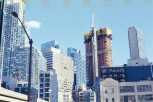 Bright and vibrant view of New York City's modern skyscrapers under a blue sky.