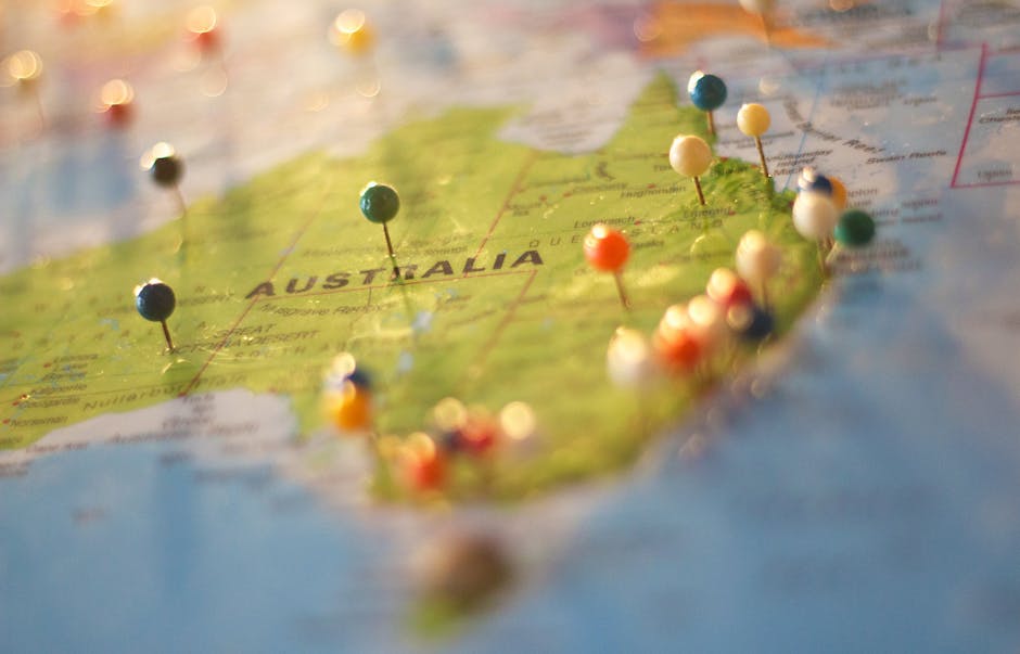 Close-up of a map of Australia with colorful pins marking various cities and destinations.